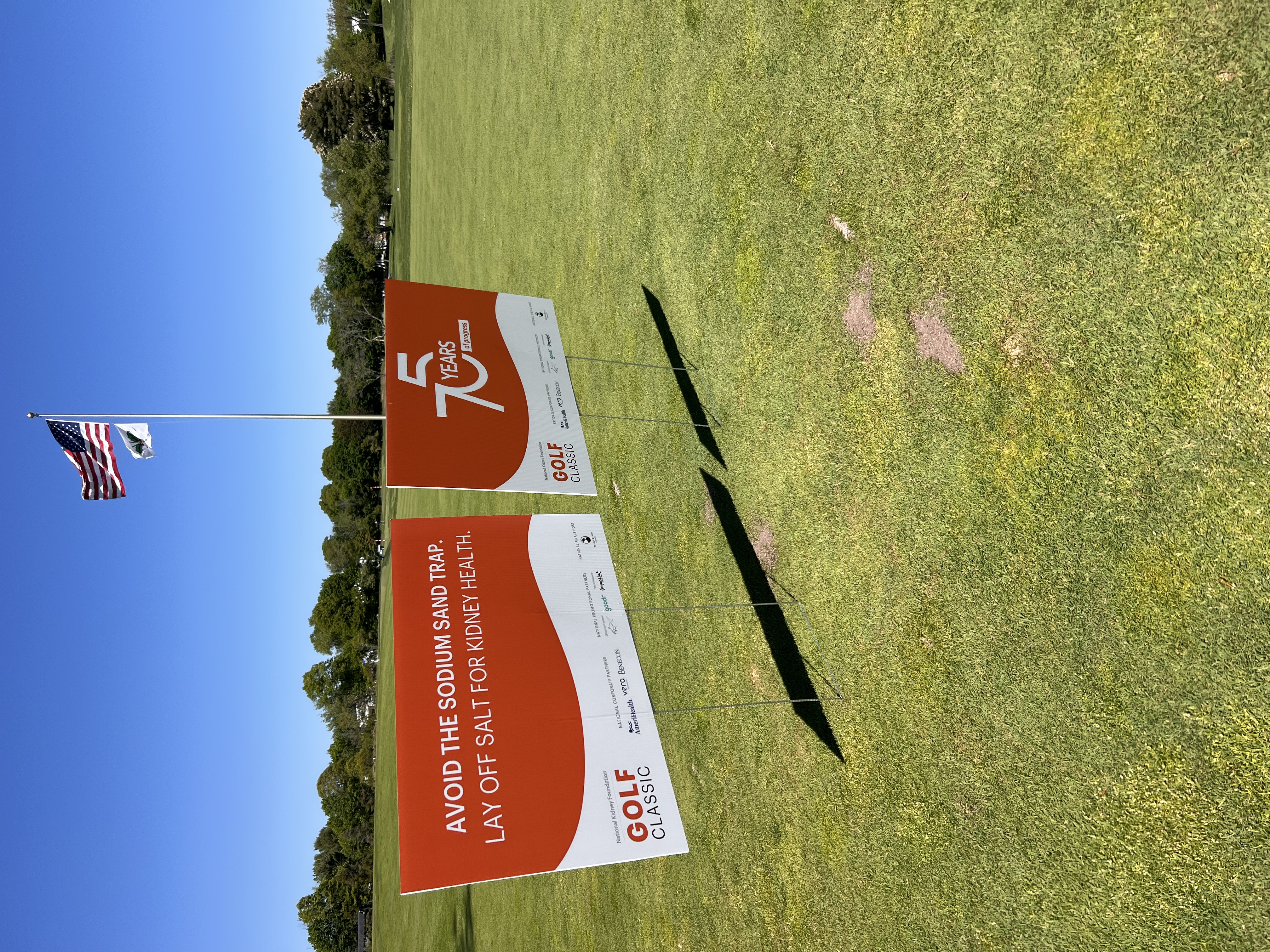 A 75 Years of Progress sign at the 2026 NKF Golf Classic