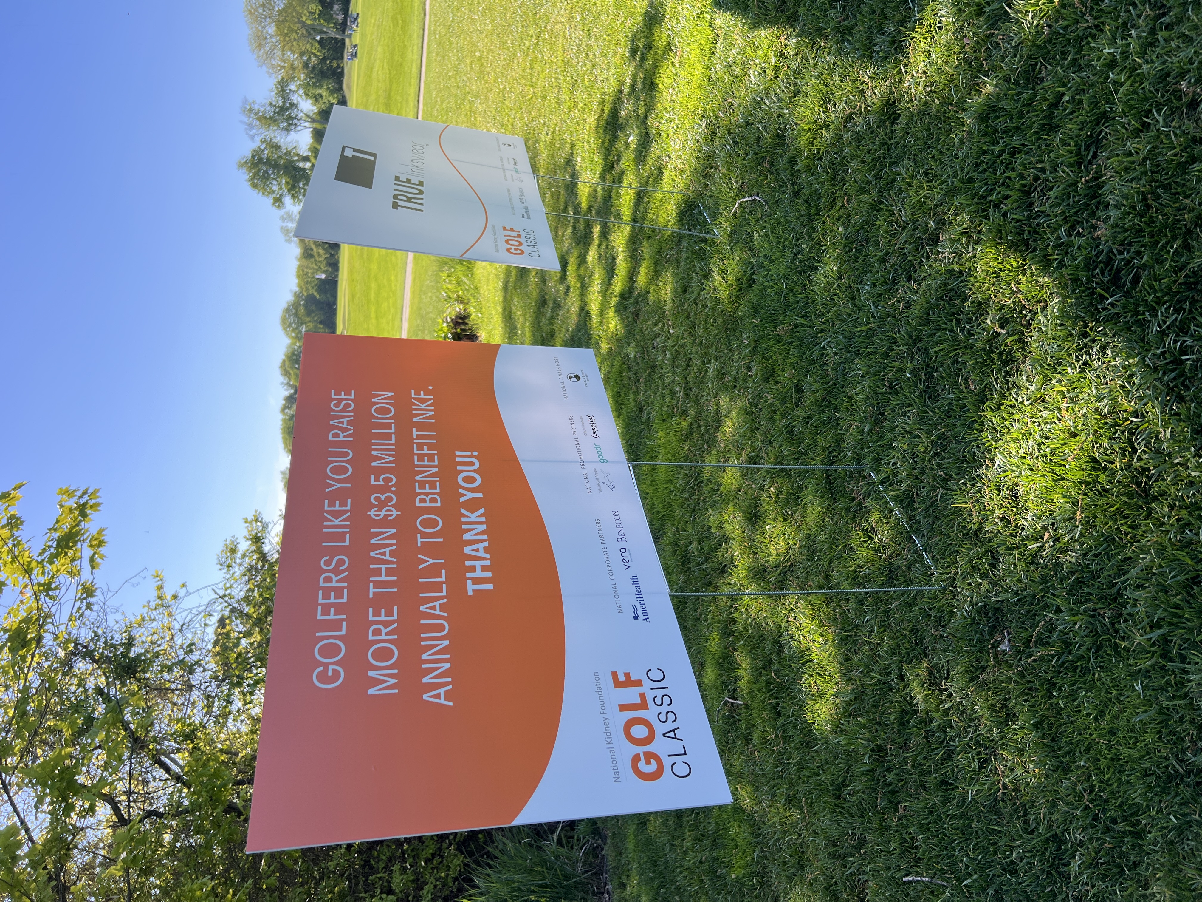 Signage at the 2026 NKF Golf Classic noting that golfers raise more than $3.5 million annually to benefit NKF