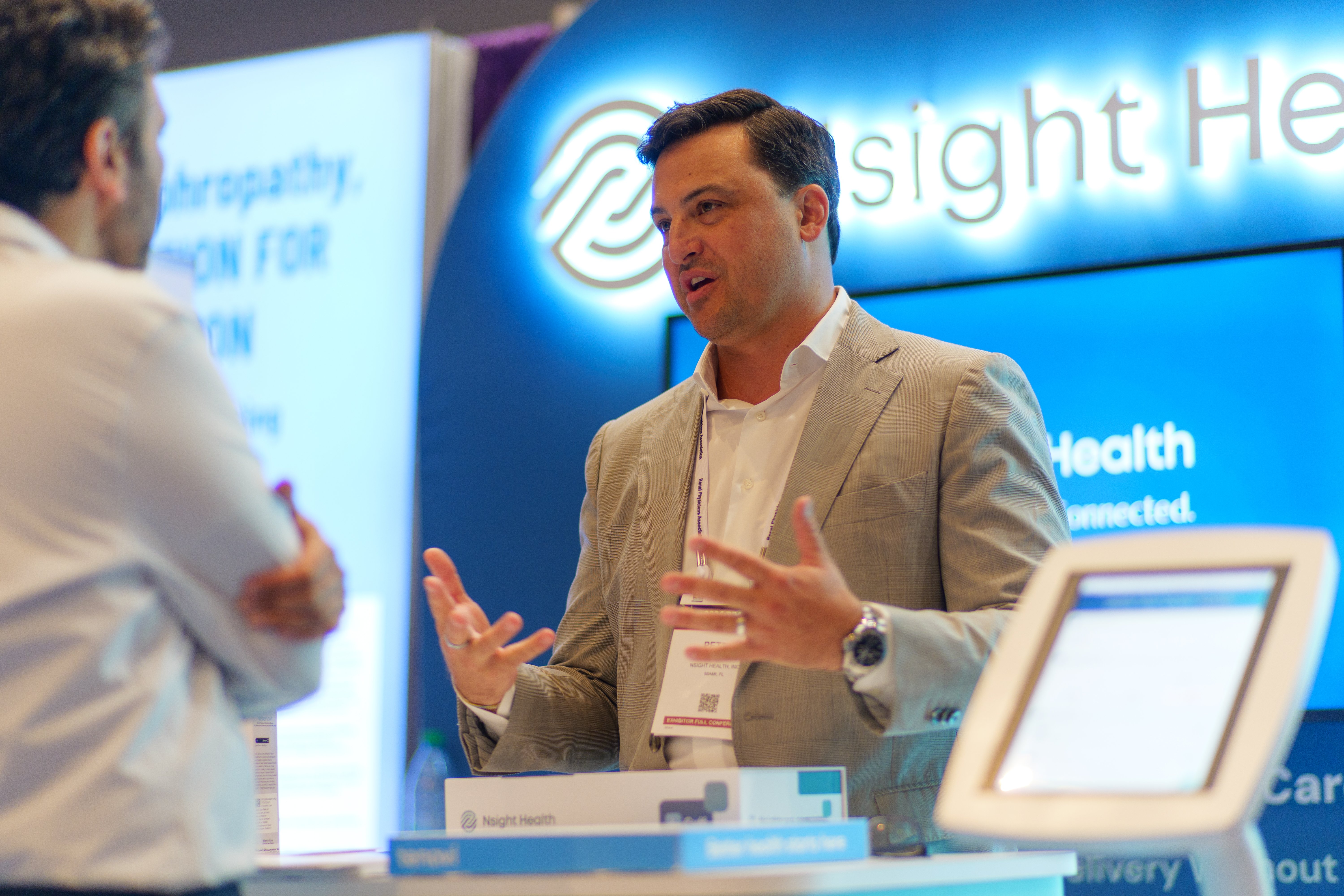 Nsight Health booth conversation with attendee at RPA 2026
